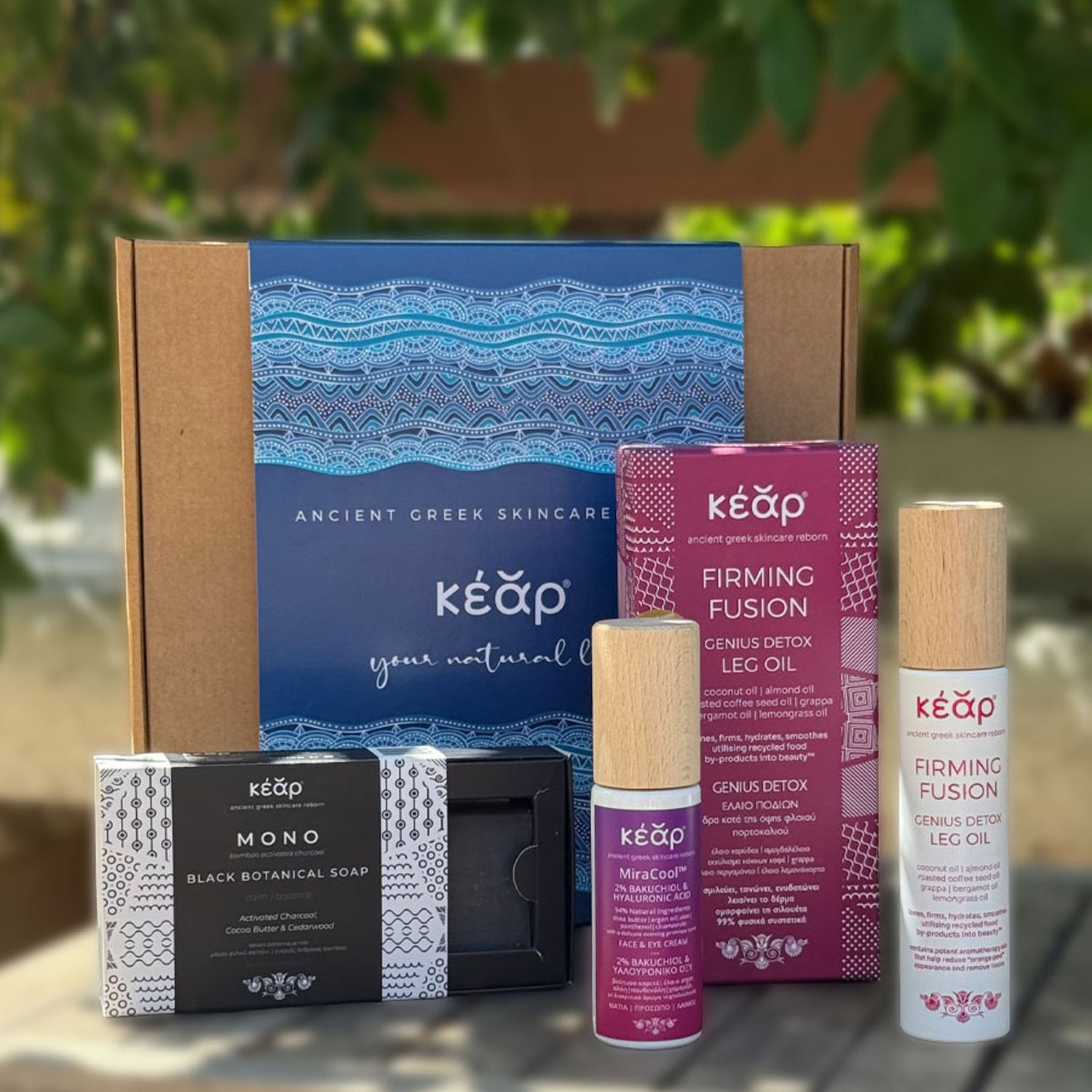 Closeup of Kear gift set with MiraCool face, eyes cream, Firming Fusion body oil, and MONO black botanical soap.