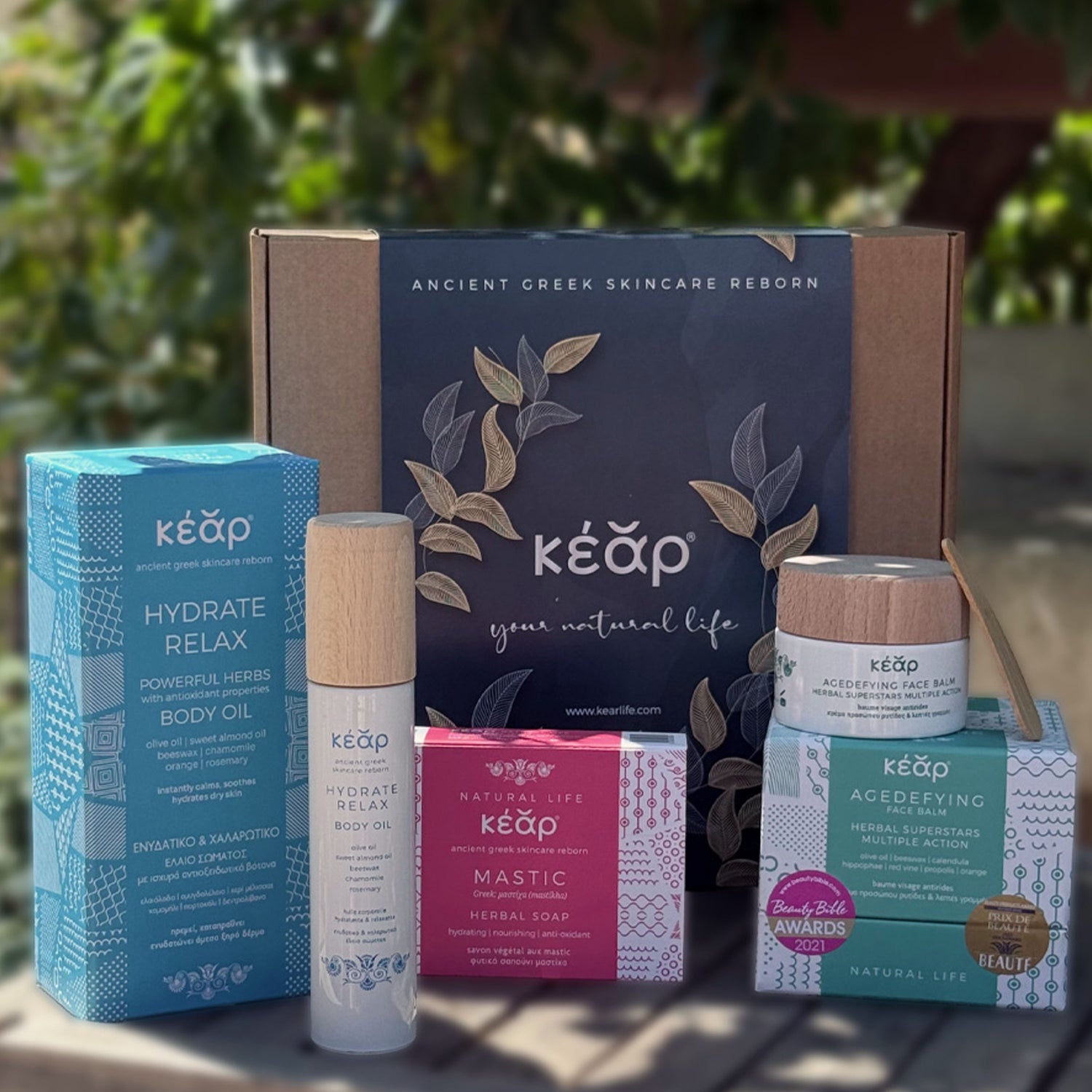 Closeup of Kear natural skincare beauty set with AgeDefying face balm, MiraCool face and eyes cream, and MONO black Botanical Herbal Soap.