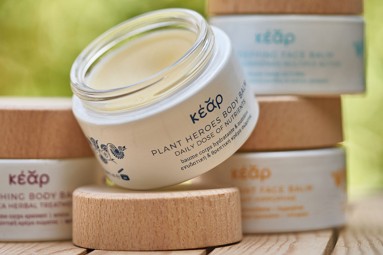 Closeup of Kear Plant Heroes body balm, with other waterless balms in the background.