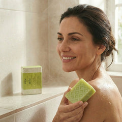 Woman using Kear Sage Olive Leaf Soap with 98% natural ingredients for body.