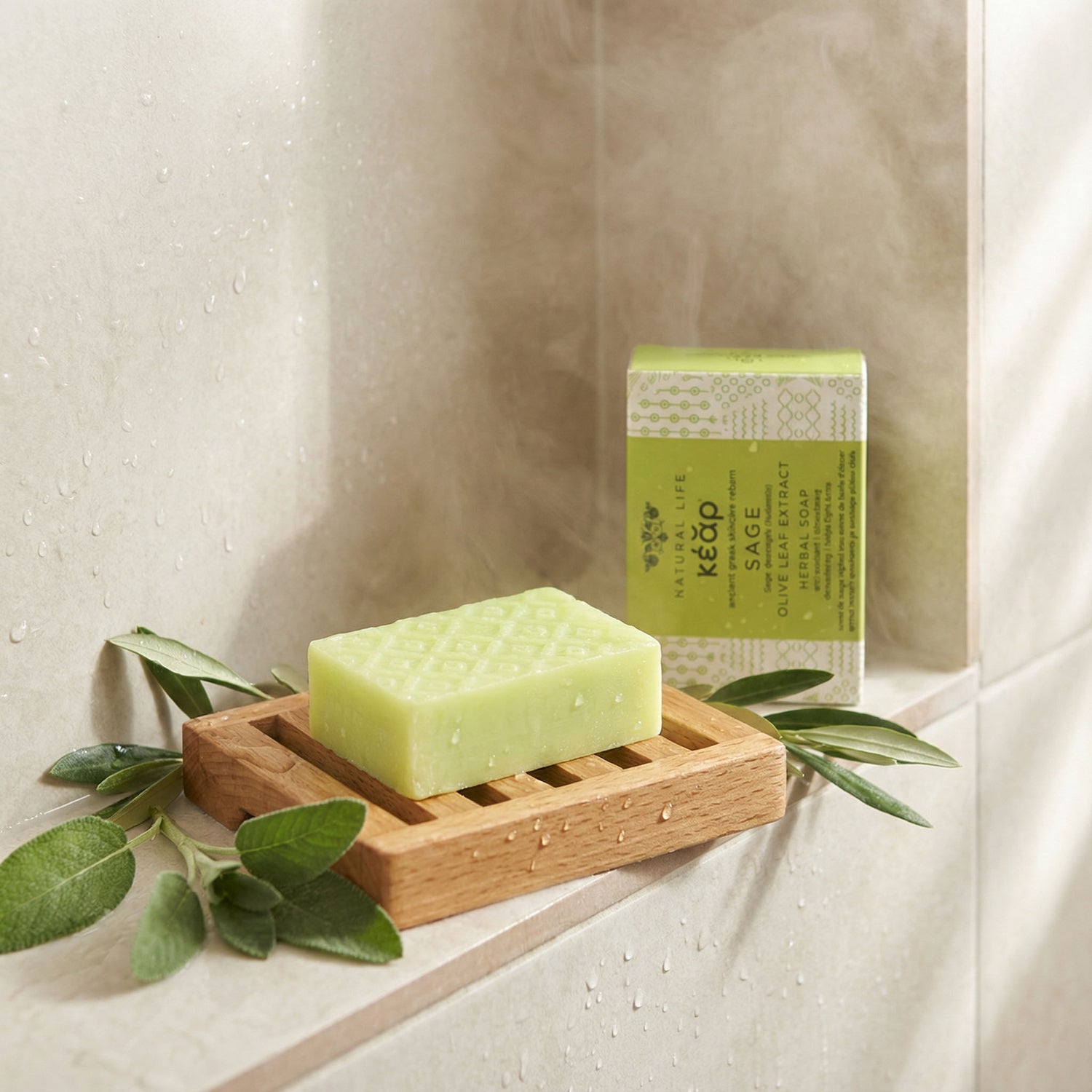 KEAR Sage Olive Leaf extract herbal soap on a wooden soap dish with its soap box in the background.