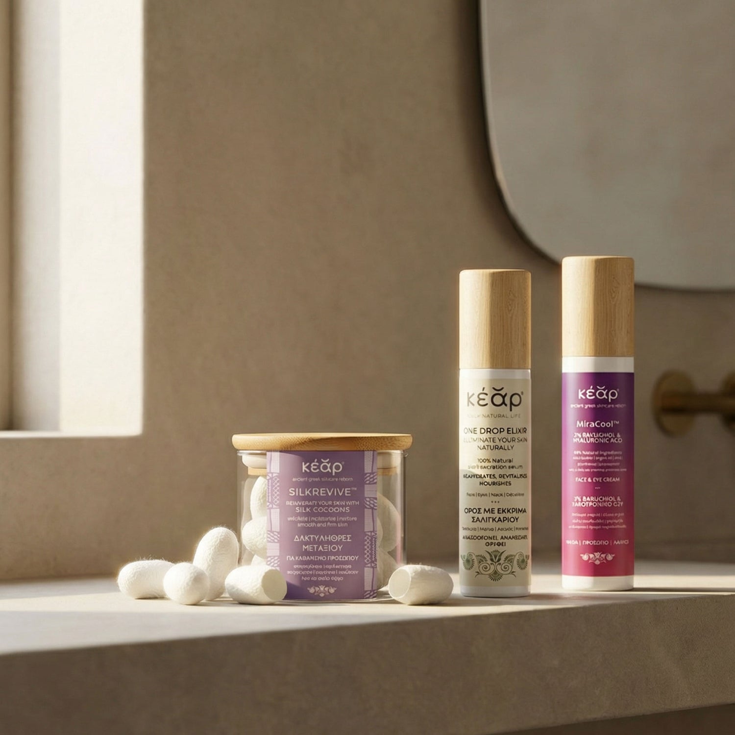 Kear Silk Revive silk cocoons, MiraCool Face, Eyes cream and One Drop Elixir Serum on a bath counter top.