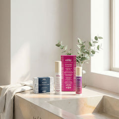 Kear MiraCool face, eyes cream, Firming Fusion body oil, and MONO black botanical soap on a marble bathroom countertop.