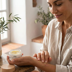 Woman applying Kear Plant Heroes waterless regenerating body balm on scar.