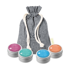 Set of four Kear travel size mini face and body balms with branded pouch.